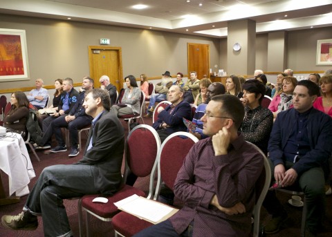 Audience listens to Alan McCully's Address
